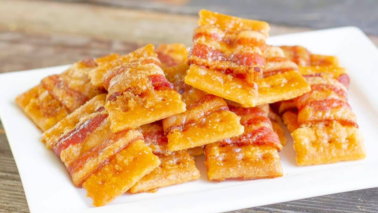 bacon wrapped crackers on a plate
