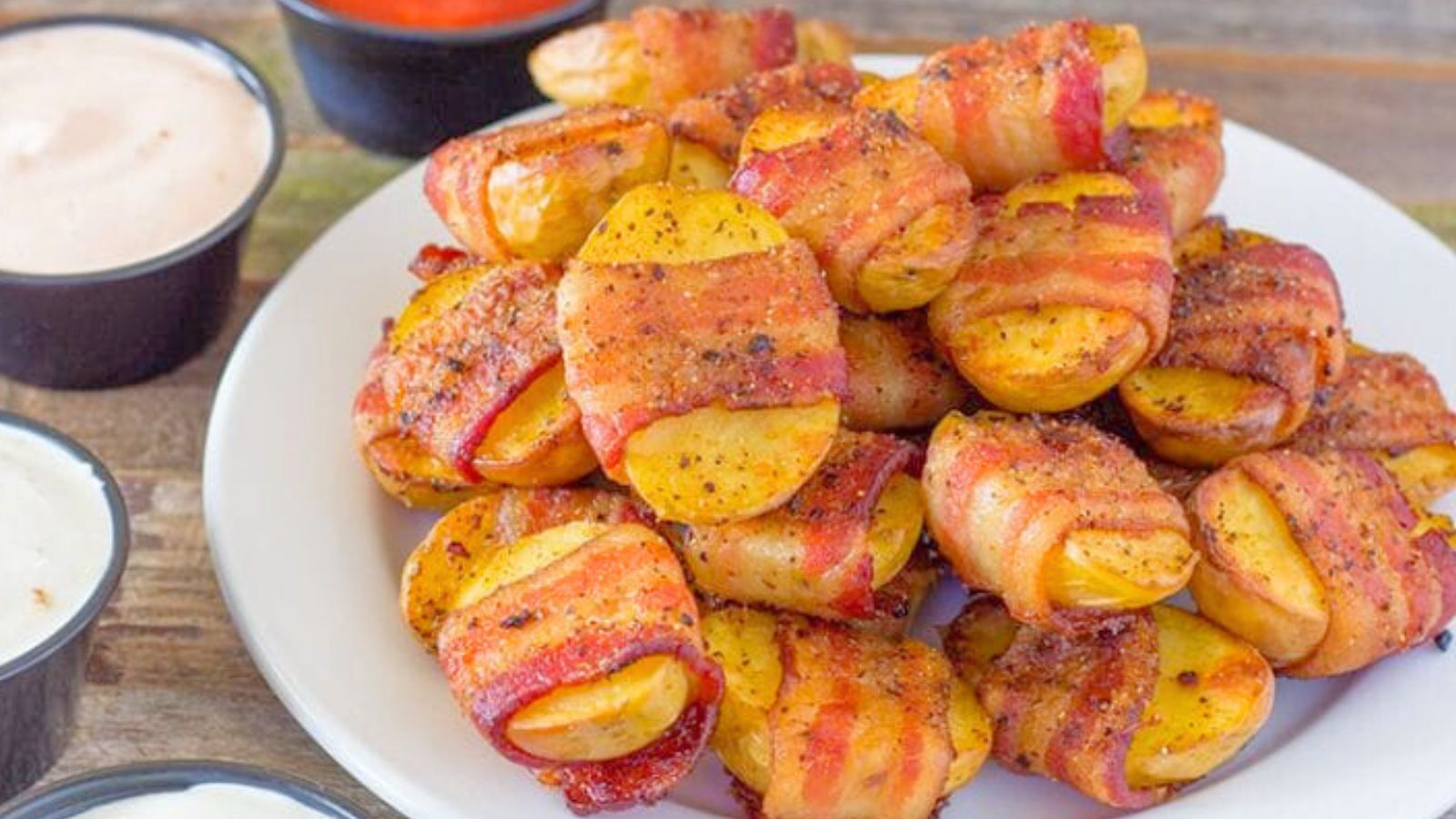 Potatoes wrapped in bacon on a plate