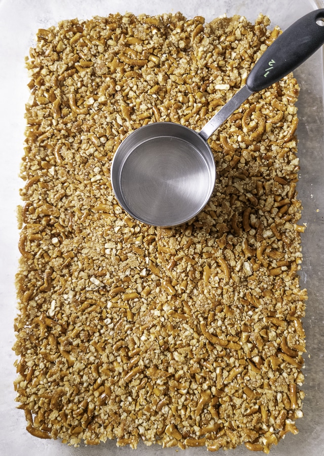 Pressed pretzel crust with a measuring cup on top