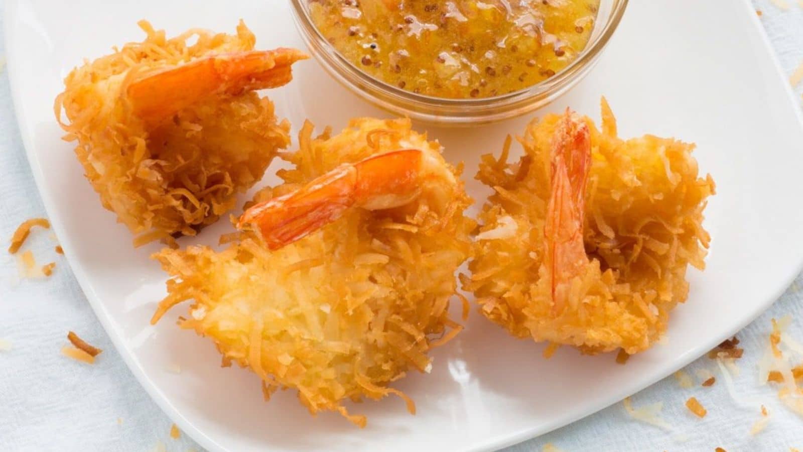 coconut shrimp on a plate with orange marmalade sauce