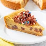 Slice of cookie cake with chocolate frosting and sprinkles