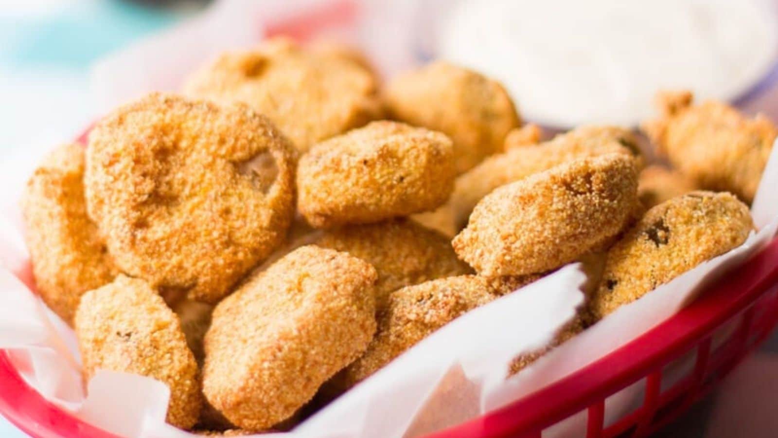 Fried pickles in a paper lined basket