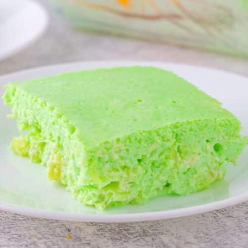 Green jello salad made with pineapple and cream cheese on a plate