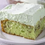 pistachio cake topped with pistachio pudding frosting