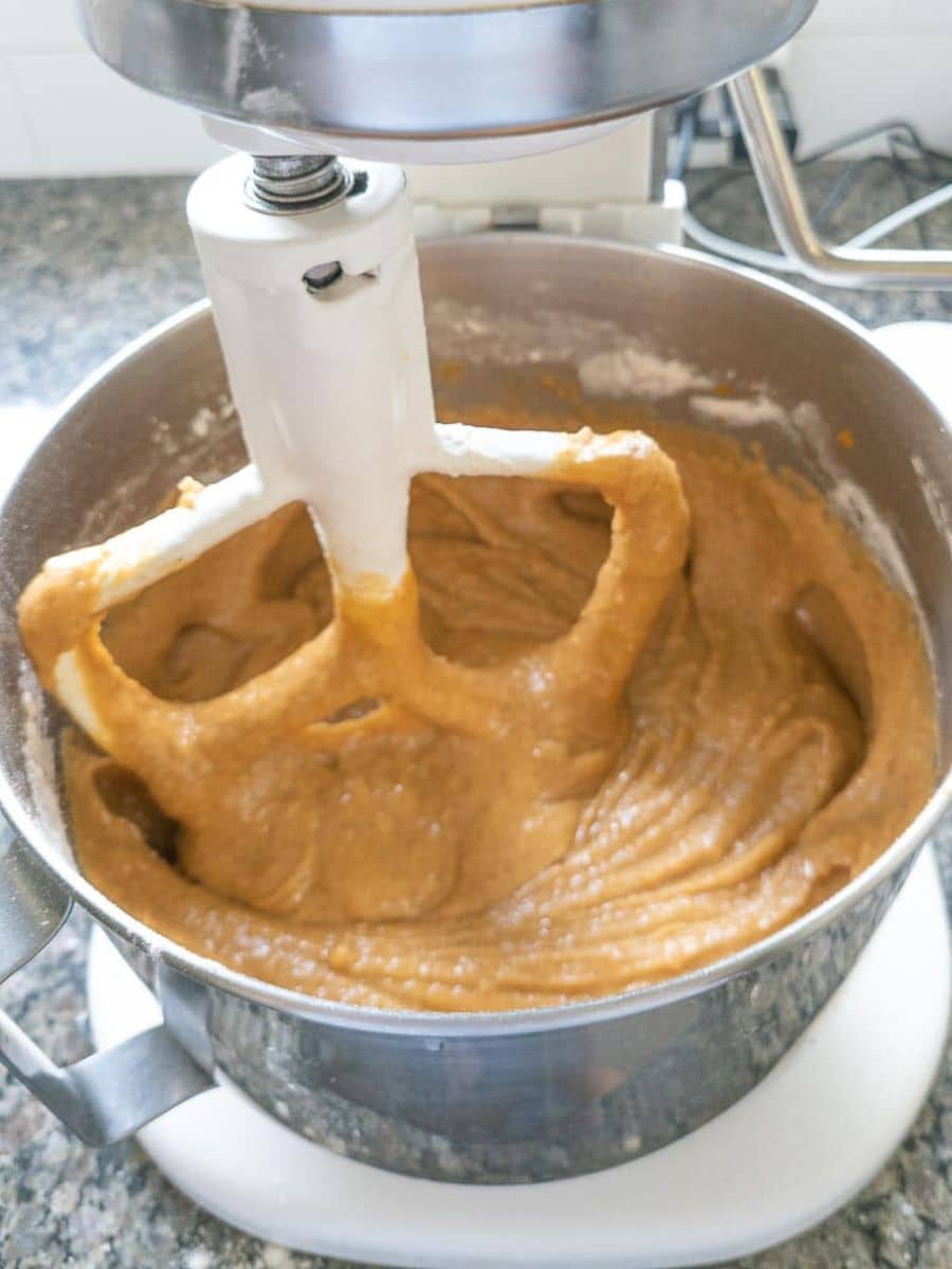Pumpkin bread batter in a mixing bowl with a beater
