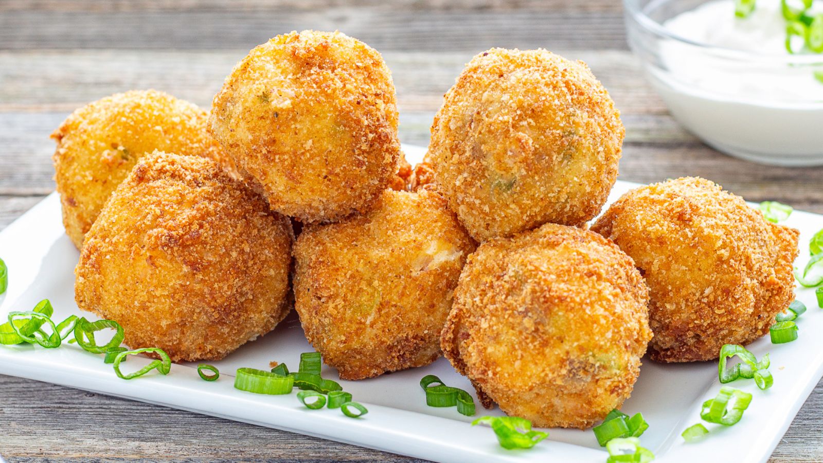 Mashed Potato Balls on a plate with green onions