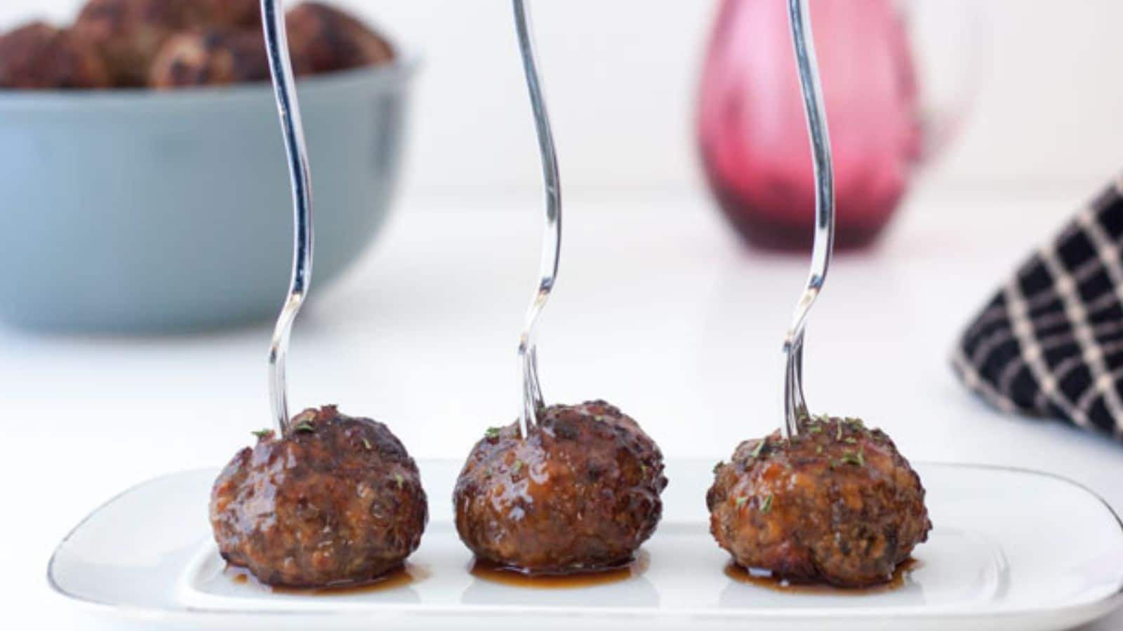 Air fryer meatballs with a fork in them on a plate