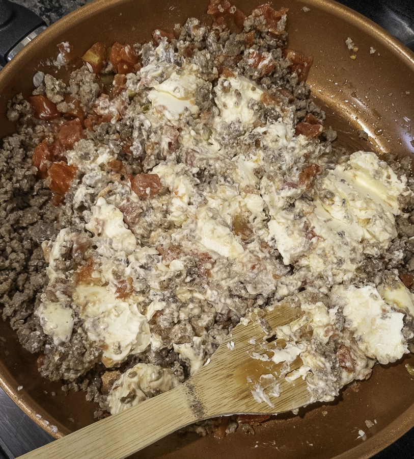 warming Rotel dip in a skillet
