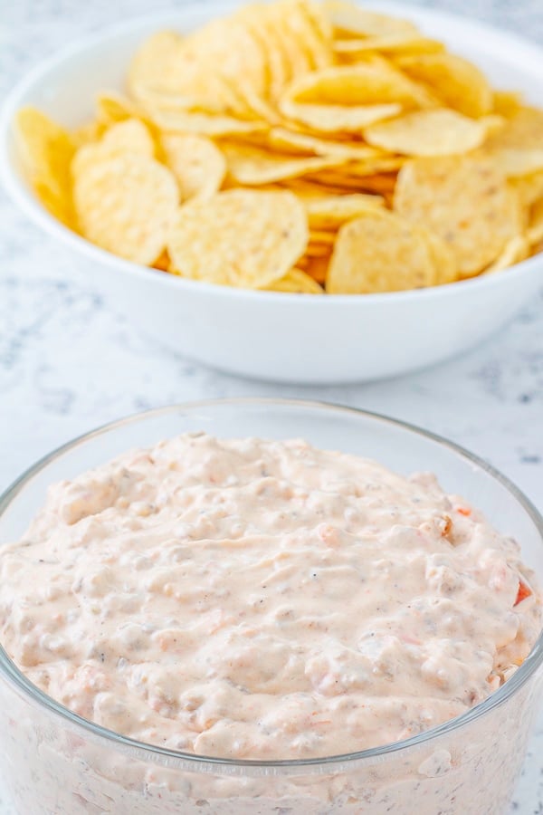 Rotel dip in a bowl in front of a bowl of chips
