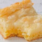 Ooey gooey butter cake slice with a bite out of it