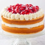 white forest cake on a glass stand