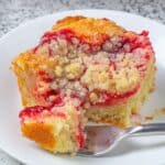 cream cheese coffee cake with strawberry on a plate with a fork