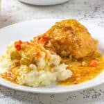Chicken and potatoes with gravy on a plate