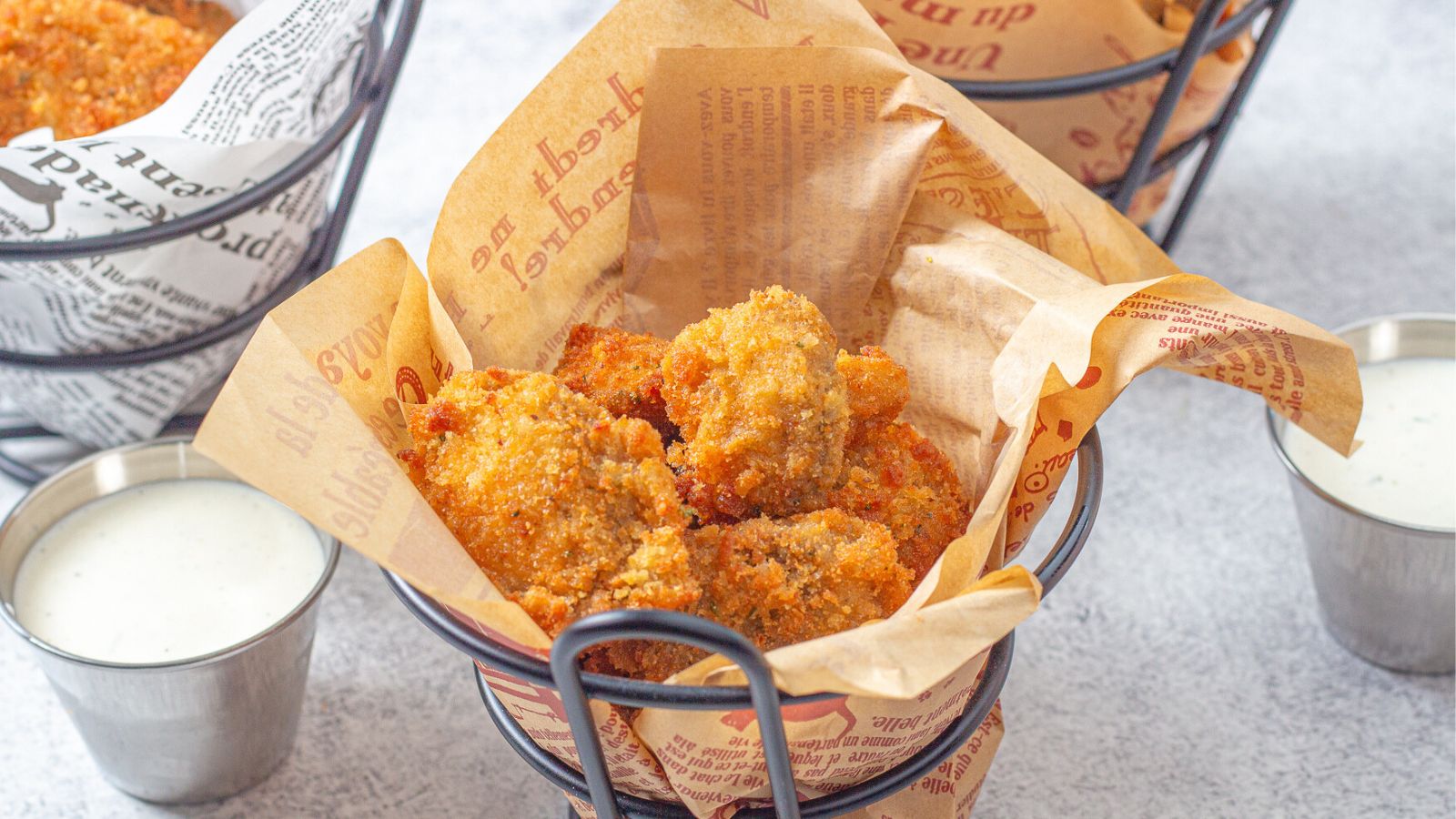 Fried mushrooms in a basket with ranch dipping sauce