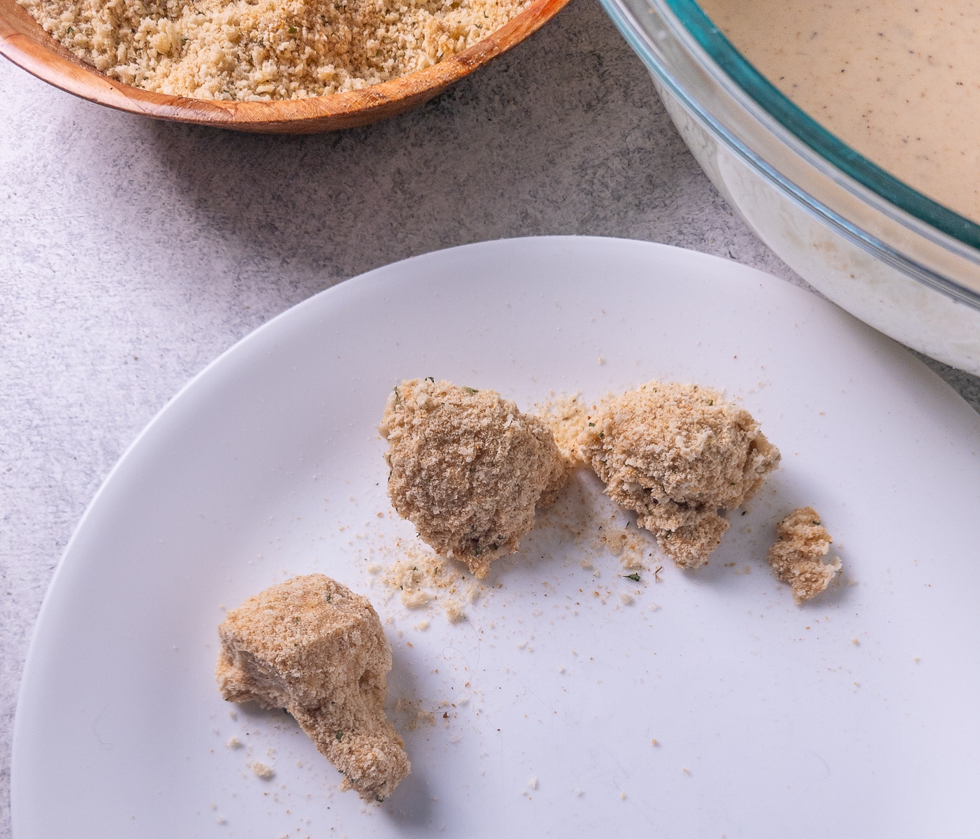Mushrooms coated in batter and breadcrumbs on a plate