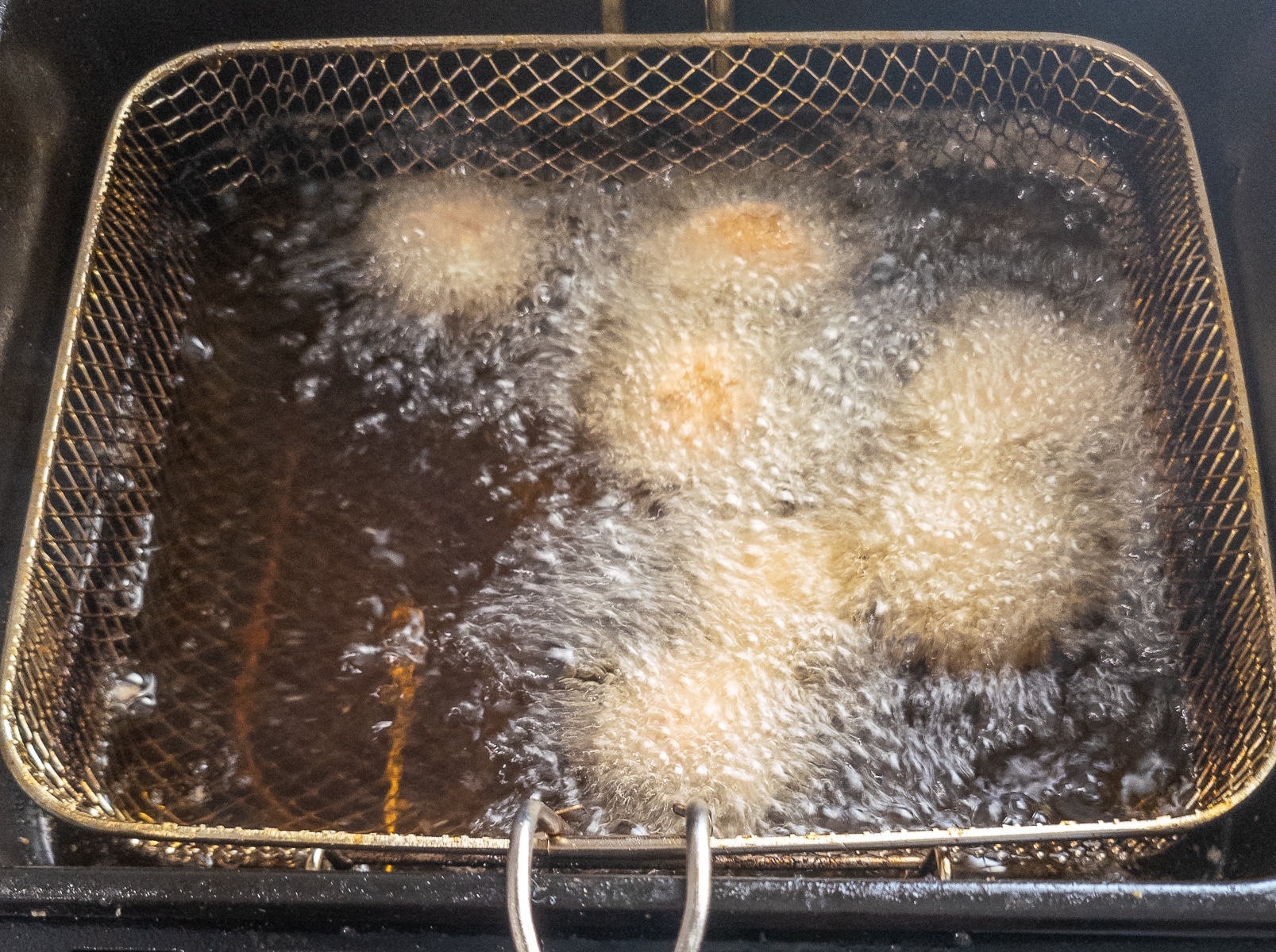 Battered mushrooms frying