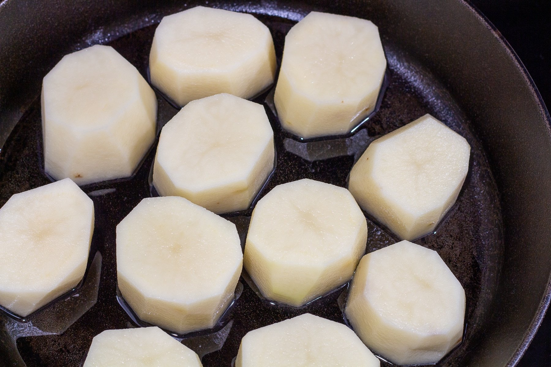 Raw potatoes in a skillet