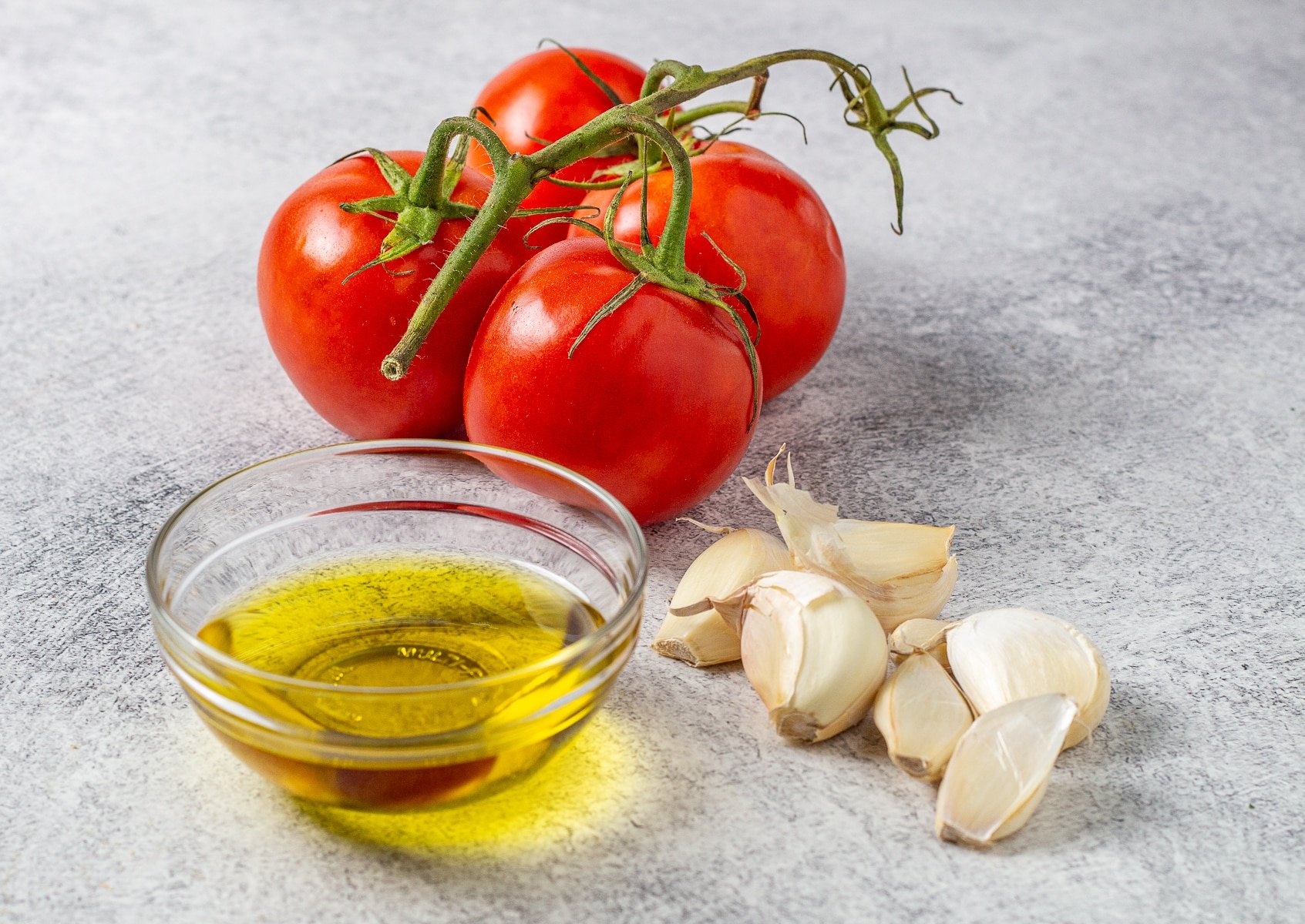 tomatoes, olive oil, and garlic cloves