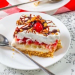 slice of banana split cake on a plate with a fork