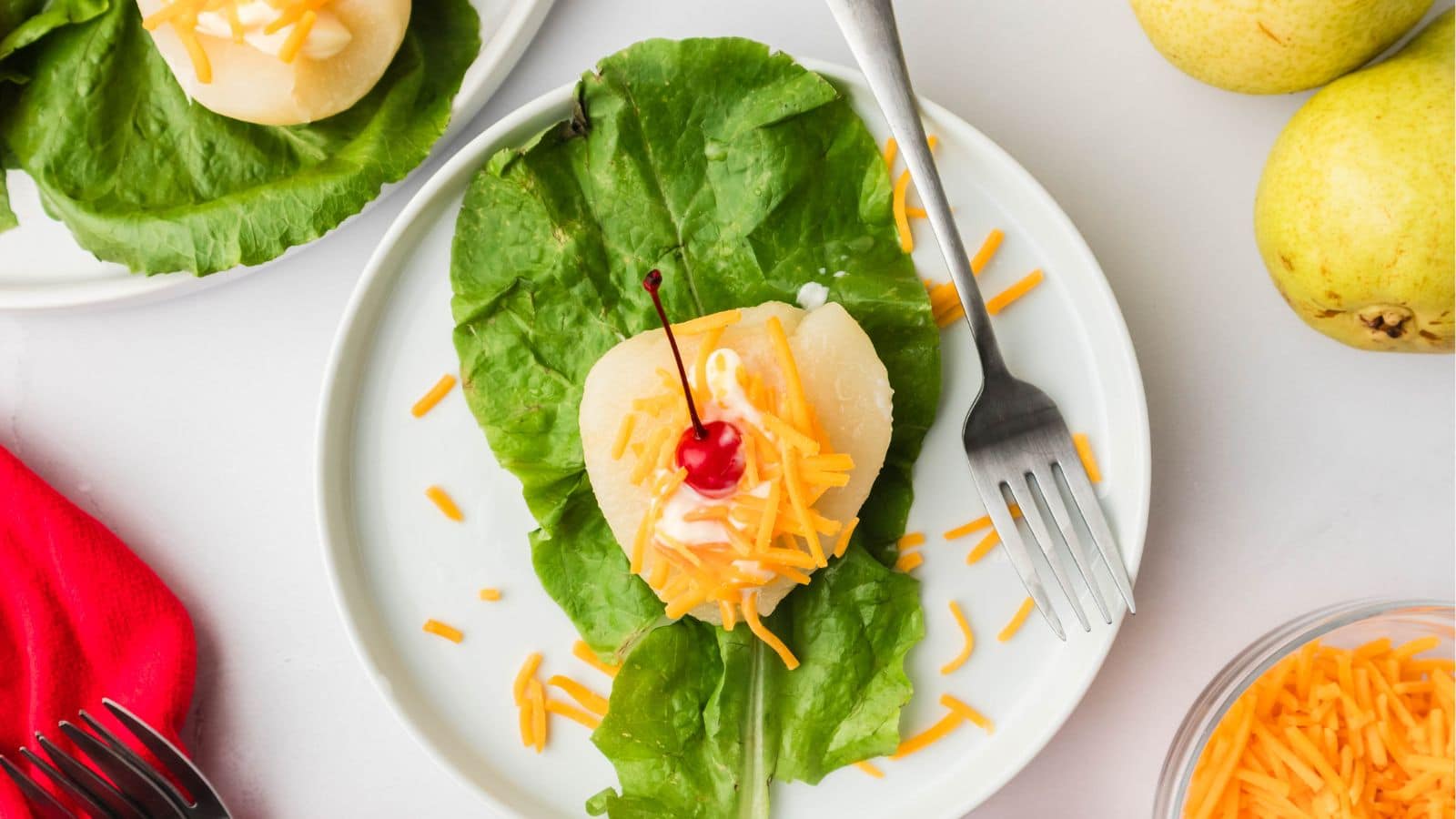 lettuce topped with a pear cheese and cherry
