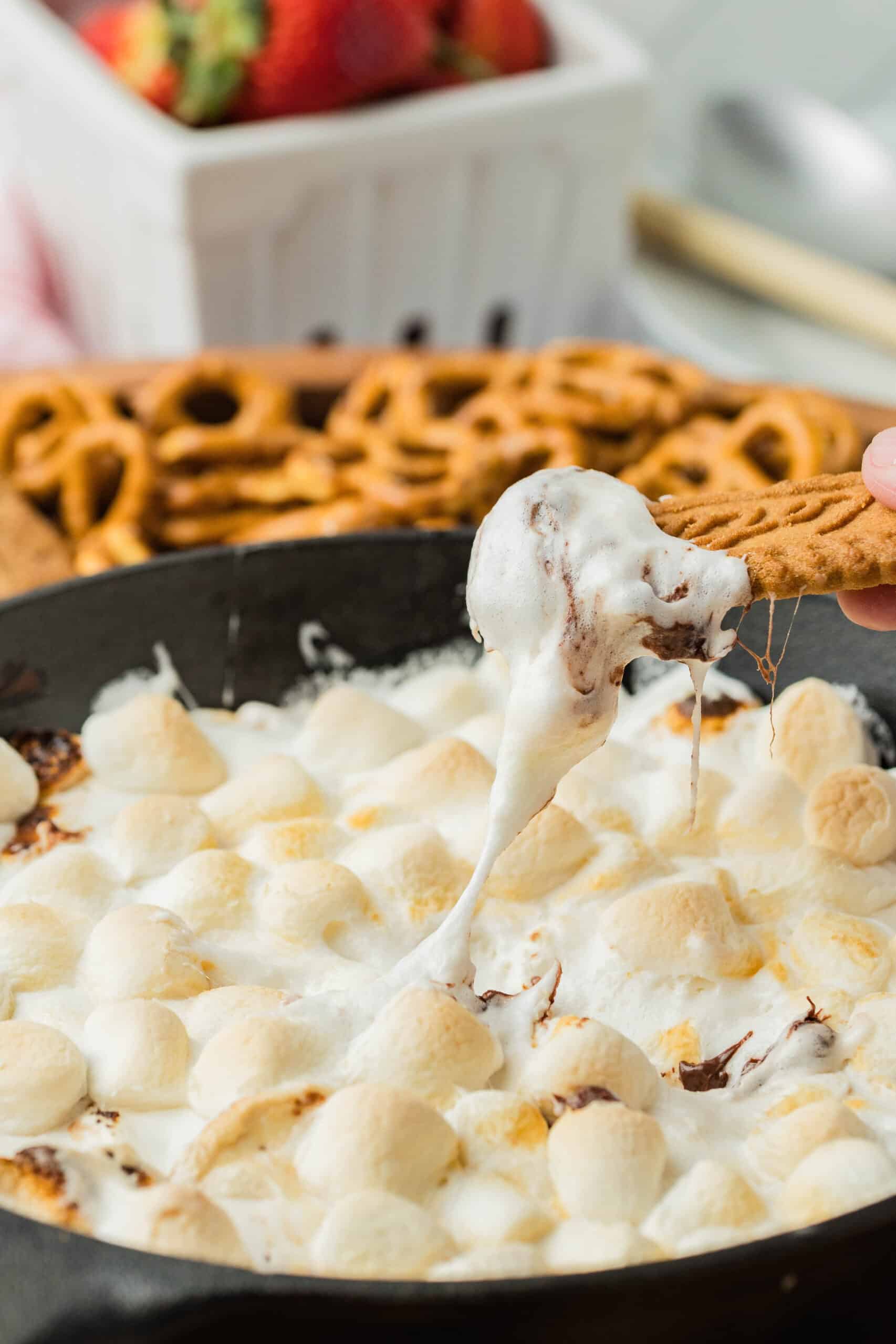 Smores dip being pulled on a cookie