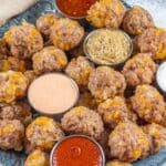 Sausage balls on a serving platter with sauces