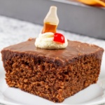 Slice of cake with cherry and coke bottle gummy