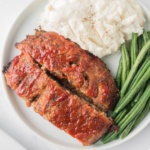 Meatloaf greens beans and potatoes on a plate