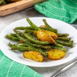 green beans and potatoes on a next to green napkins with white stripes