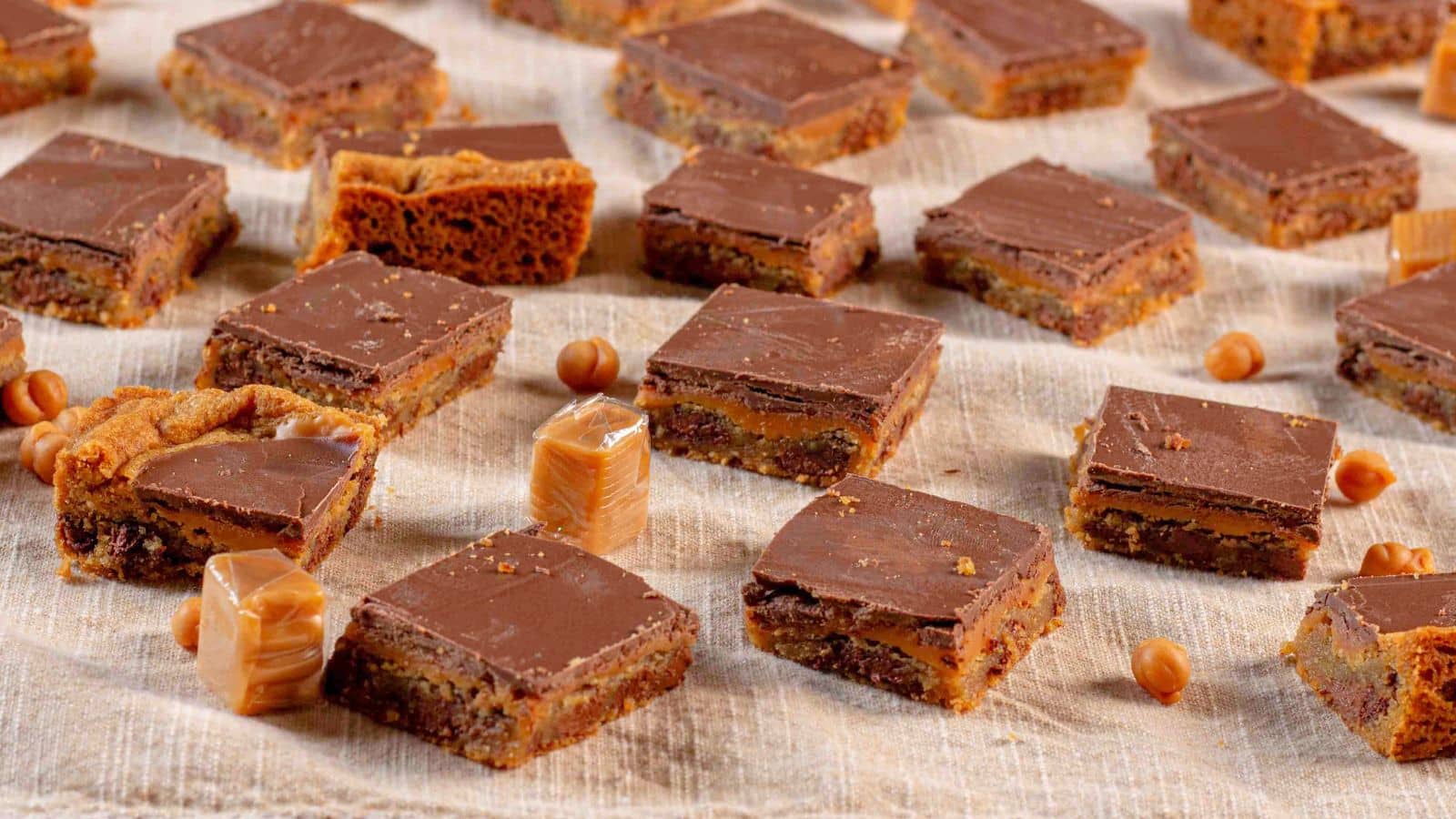 chocolate caramel cookie bar slices surrounded by caramels and caramel bits