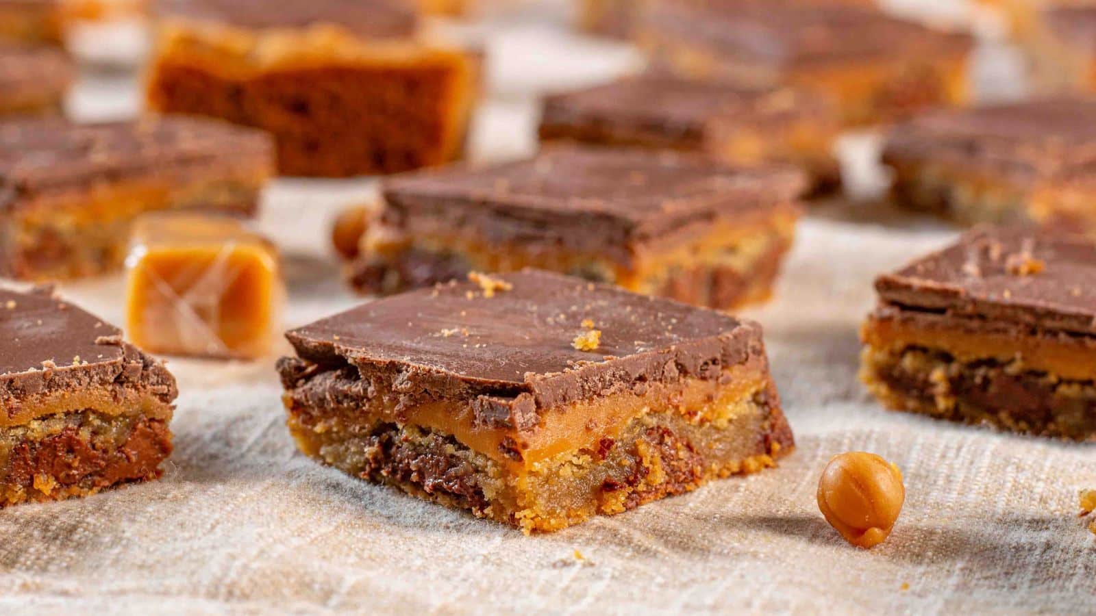 Chocolate chip cookie bar topped with caramel and chocolate