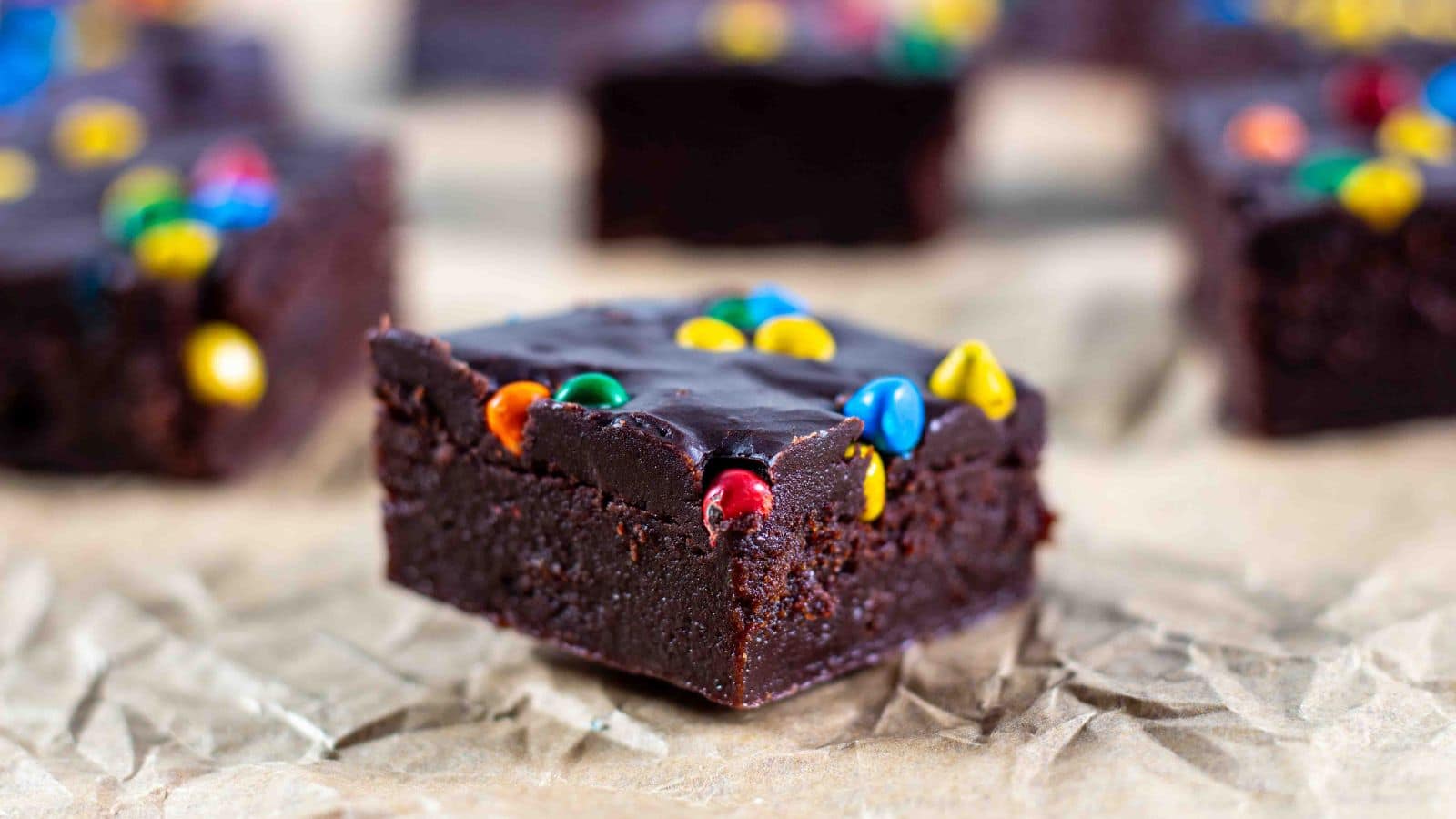 Side view of cosmic brownies on crinkled brown parchment paper