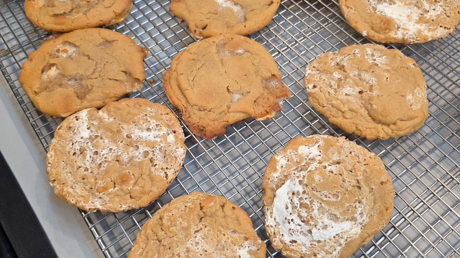 peanut butter cookies with  mini marshmallows and cookies with marshmallow fluff on a wire rack