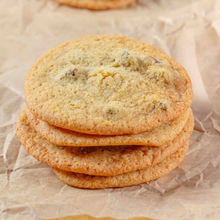 thin chocolate chip cookies stacked on brown paper