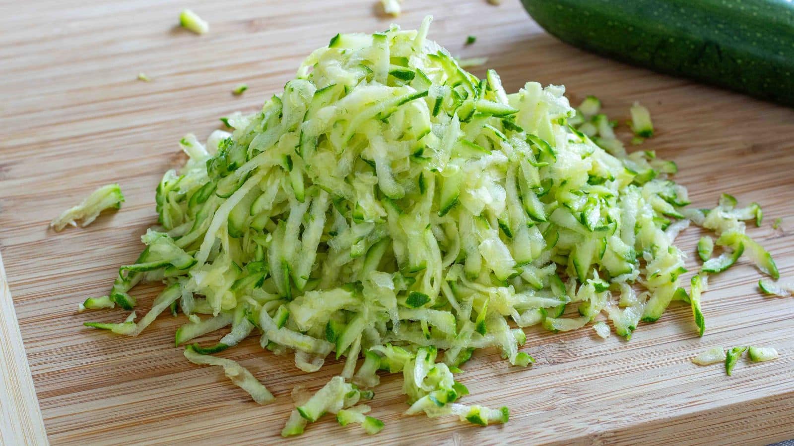 shredded zucchini on a cutting board
