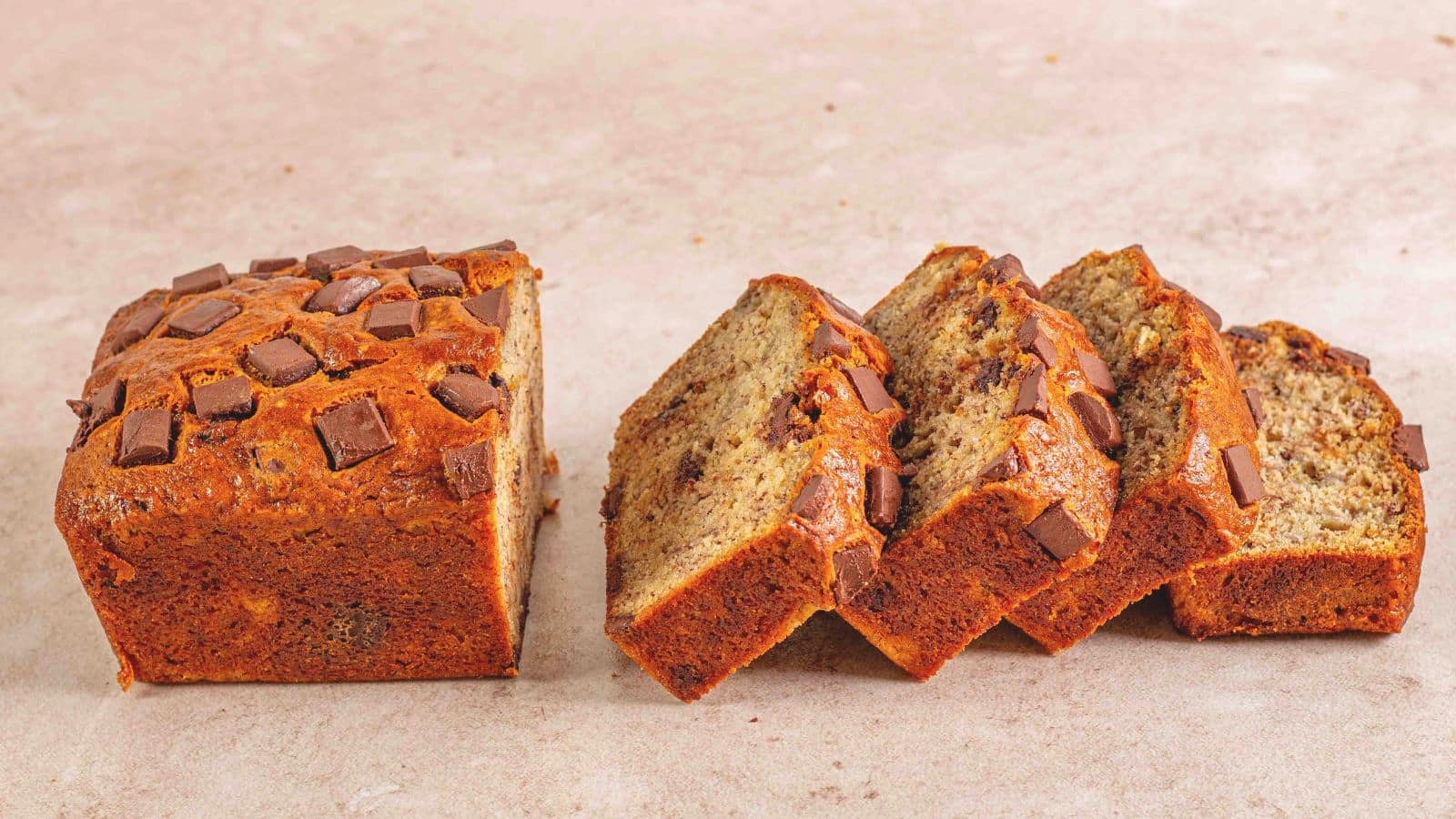 4 slices of chocolate chunk banana bread with half of an unsliced loaf