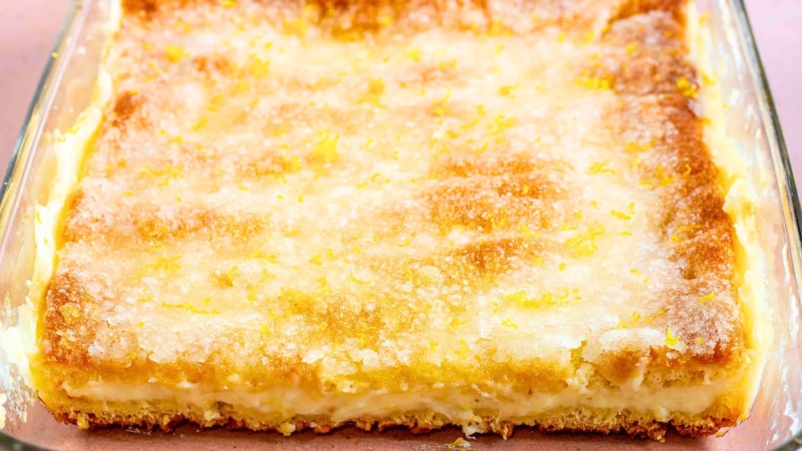 lemon cheesecake bars in a glass pan