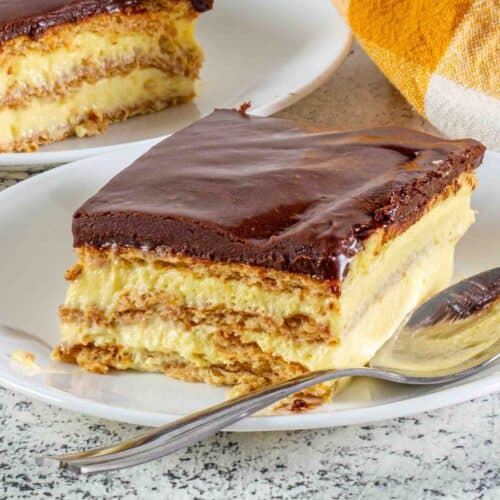 chocolate eclair cake slice on a plate with a spoon